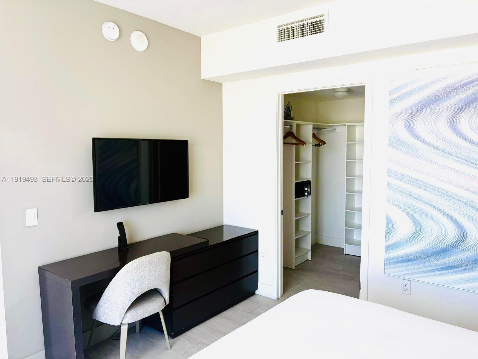 4010 South Ocean Drive, Unit R2904 Hollywood, FL 33019 - Photo 12 of 32 a living room with furniture and a flat screen tv