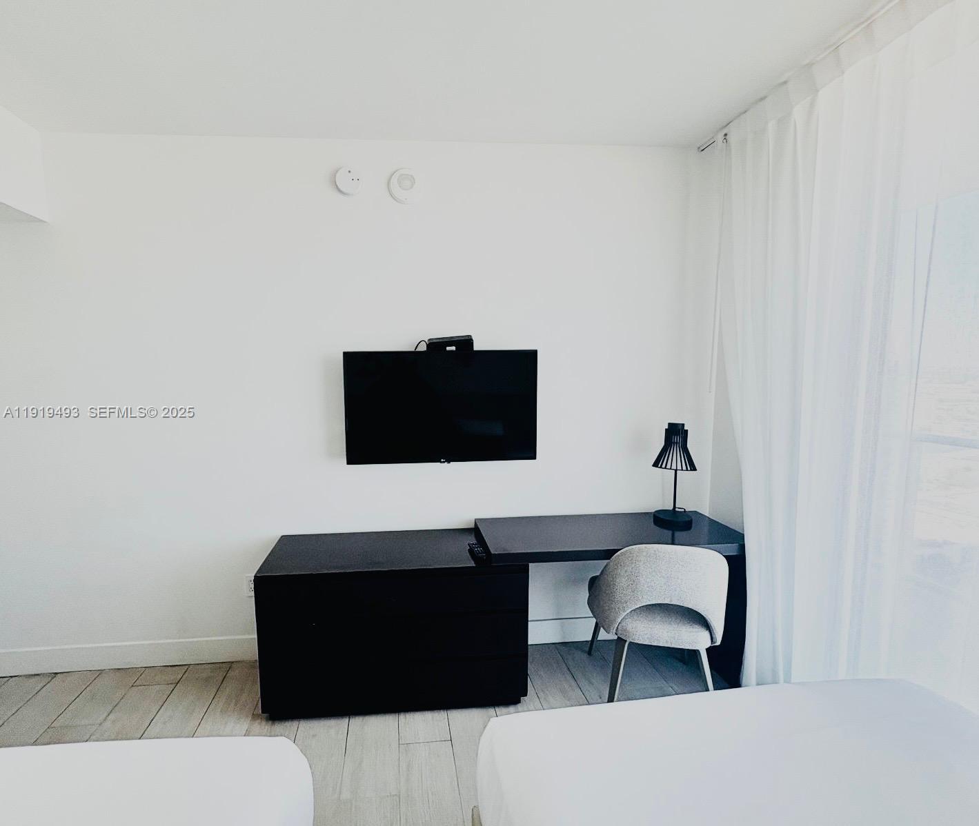 4010 South Ocean Drive, Unit R2904 Hollywood, FL 33019 - Photo 14 of 32 a living room with a couch and a flat screen tv