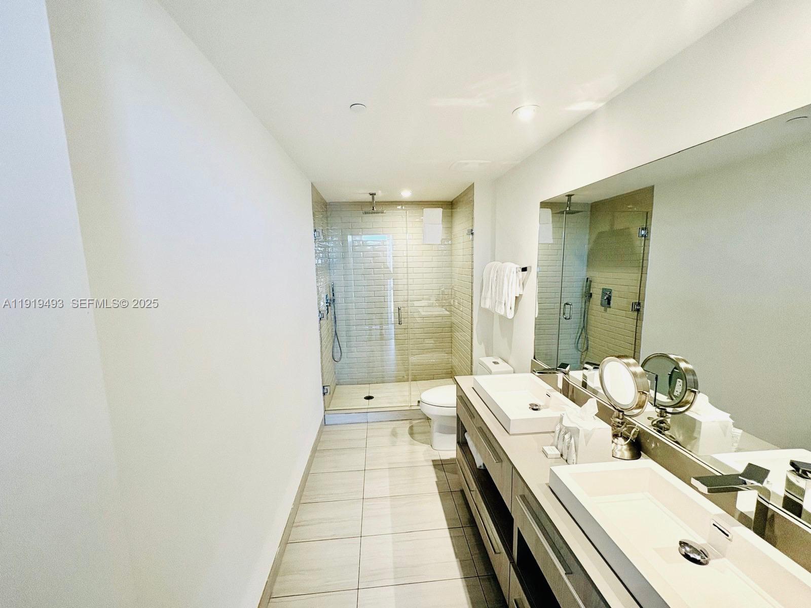 4010 South Ocean Drive, Unit R2904 Hollywood, FL 33019 - Photo 15 of 32 a bathroom with a double vanity sink and mirror