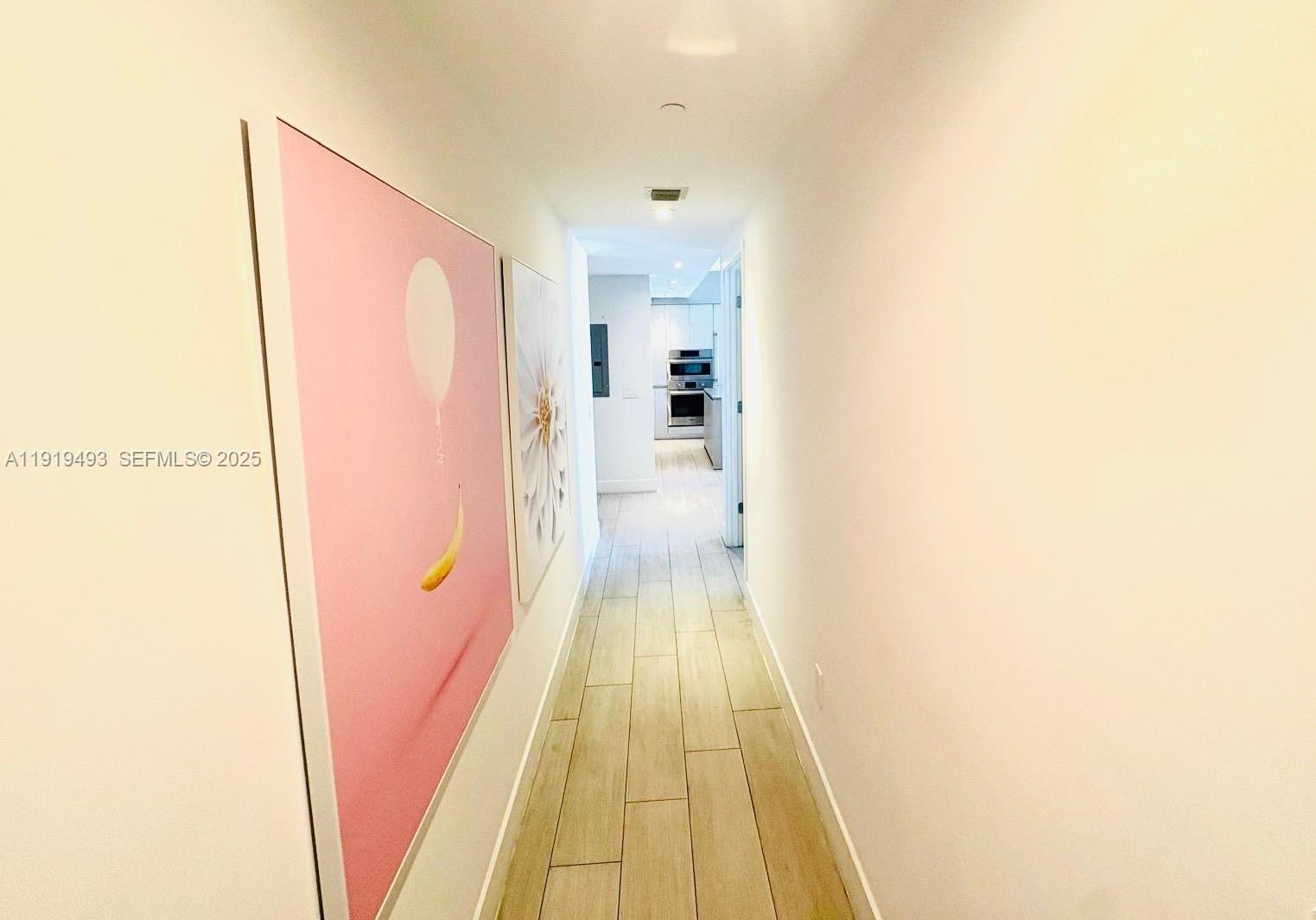 4010 South Ocean Drive, Unit R2904 Hollywood, FL 33019 - Photo 5 of 32 a view of a hallway with wooden floor