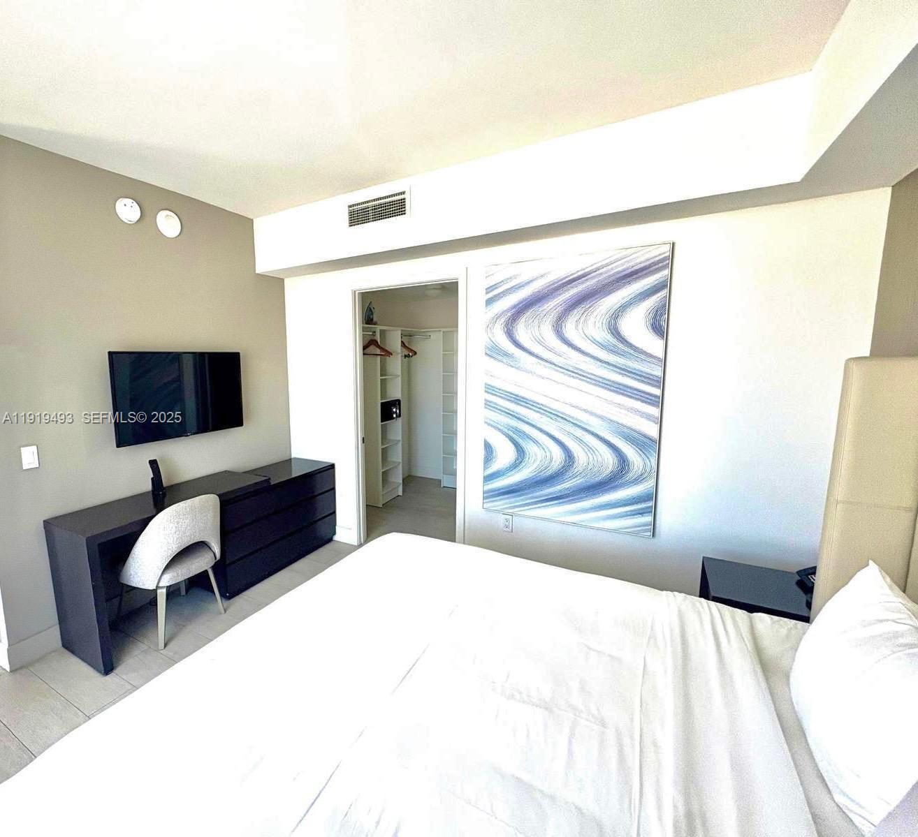 4010 South Ocean Drive, Unit R2904 Hollywood, FL 33019 - Photo 7 of 32 a bedroom with a bed and a flat screen tv