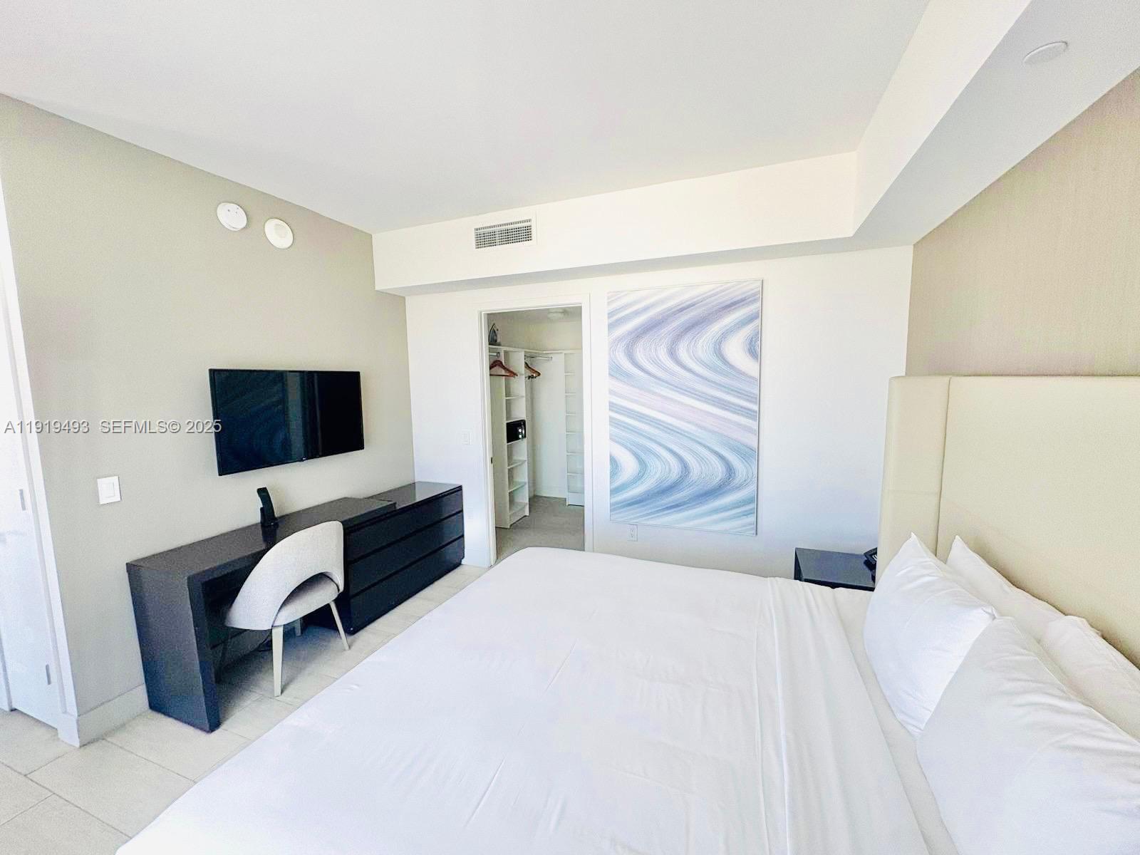 4010 South Ocean Drive, Unit R2904 Hollywood, FL 33019 - Photo 10 of 32 a bedroom with a bed and flat screen tv