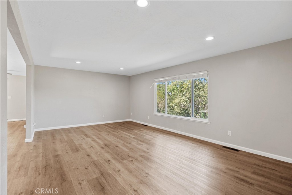 904 Long Bar Road Oroville, CA 95966 - Photo 11 of 50 an empty room with wooden floor and windows