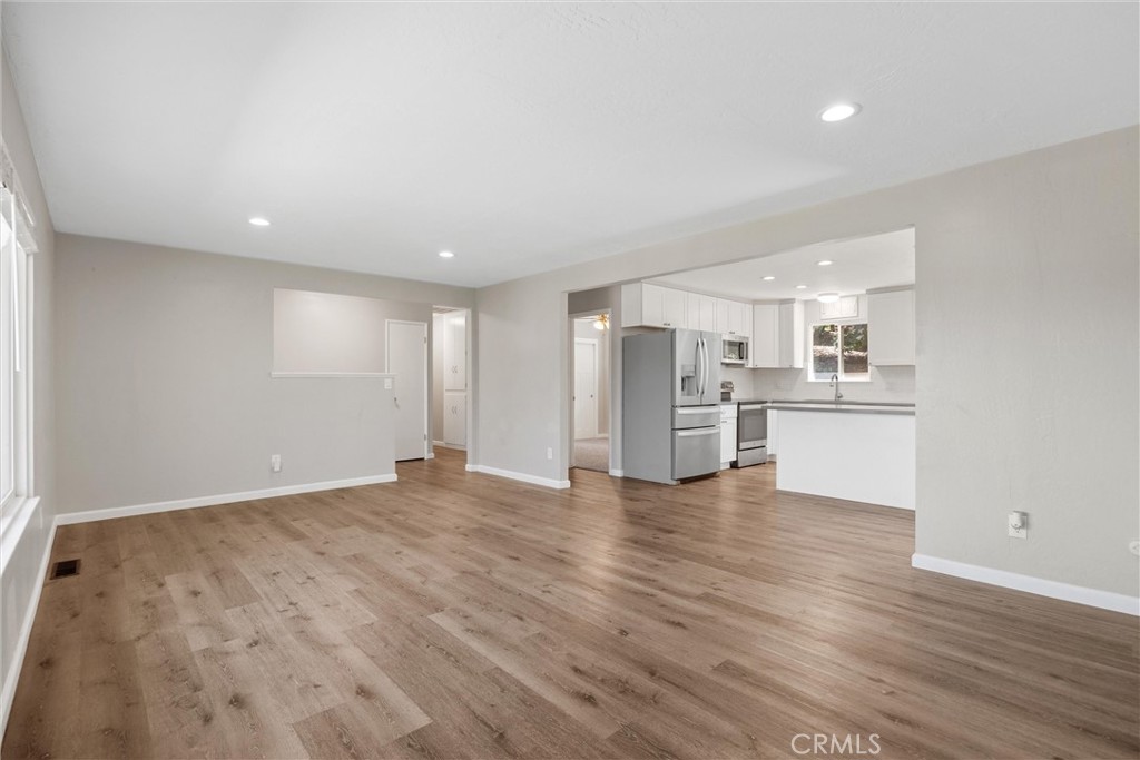 904 Long Bar Road Oroville, CA 95966 - Photo 13 of 50 a view of an empty room with wooden floor and a kitchen