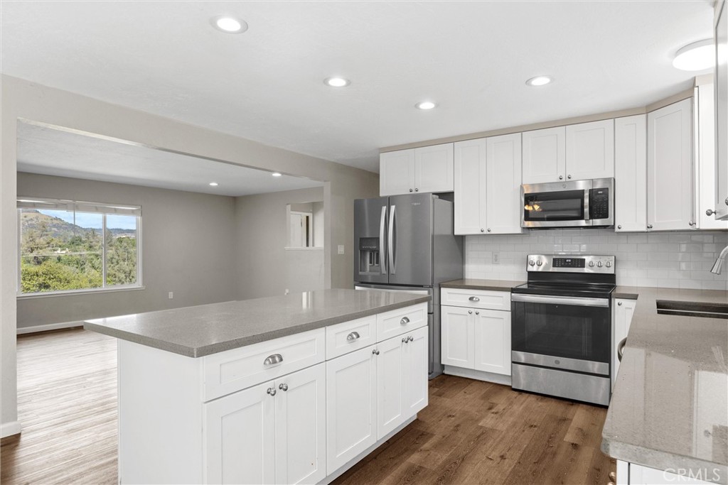 904 Long Bar Road Oroville, CA 95966 - Photo 14 of 50 a kitchen with white cabinets and stainless steel appliances