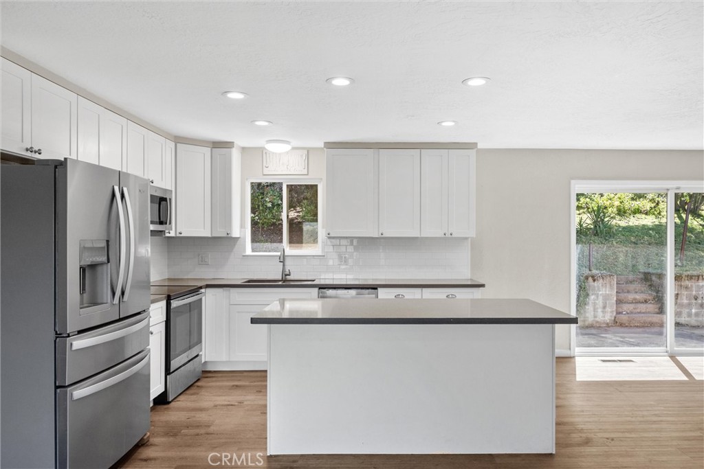 904 Long Bar Road Oroville, CA 95966 - Photo 16 of 50 a kitchen with stainless steel appliances granite countertop a refrigerator a stove a sink and a microwave