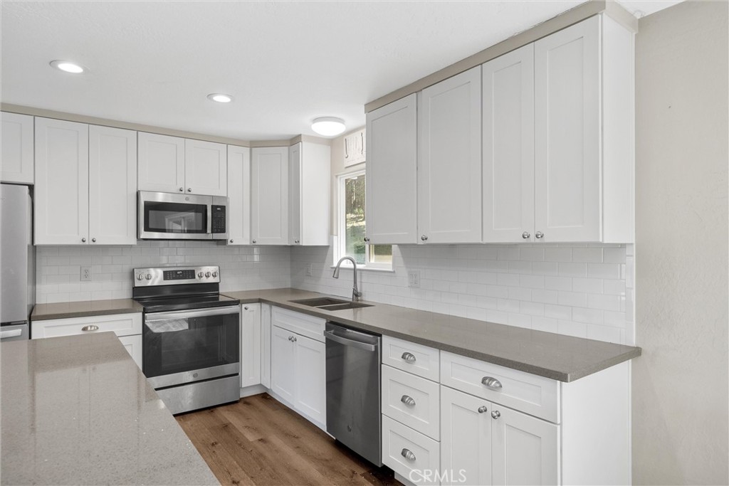 904 Long Bar Road Oroville, CA 95966 - Photo 18 of 50 a kitchen with granite countertop white cabinets and stainless steel appliances