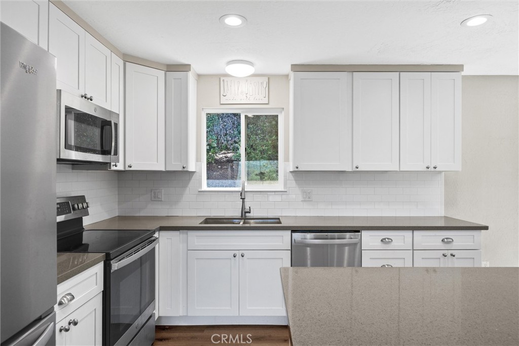 904 Long Bar Road Oroville, CA 95966 - Photo 19 of 50 a kitchen with stainless steel appliances granite countertop white cabinets granite counter tops and a window