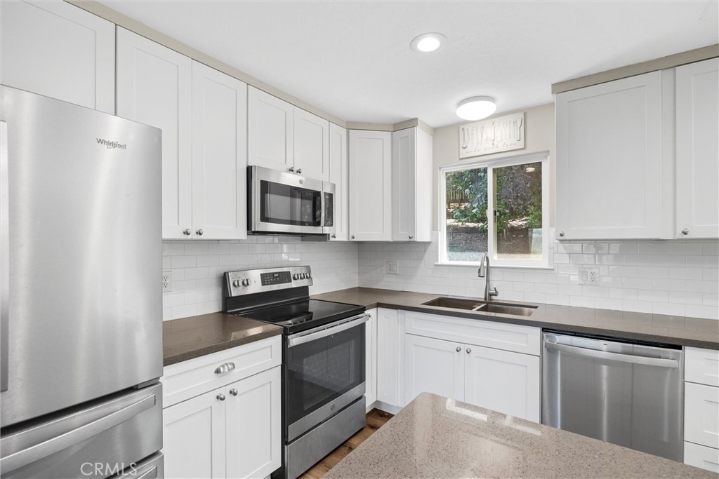 904 Long Bar Road Oroville, CA 95966 - Photo 20 of 50 a kitchen with granite countertop white cabinets white stainless steel appliances and a sink