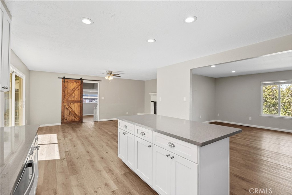 904 Long Bar Road Oroville, CA 95966 - Photo 22 of 50 a kitchen with white cabinets and wooden floor