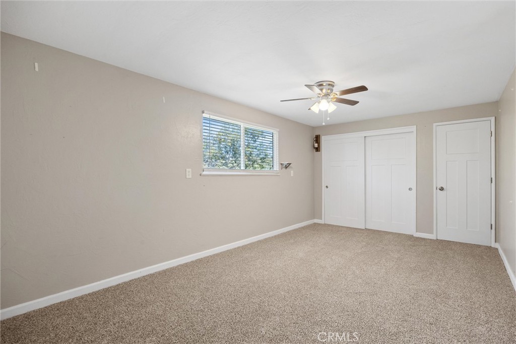 904 Long Bar Road Oroville, CA 95966 - Photo 35 of 50 an empty room with a chandelier fan and windows