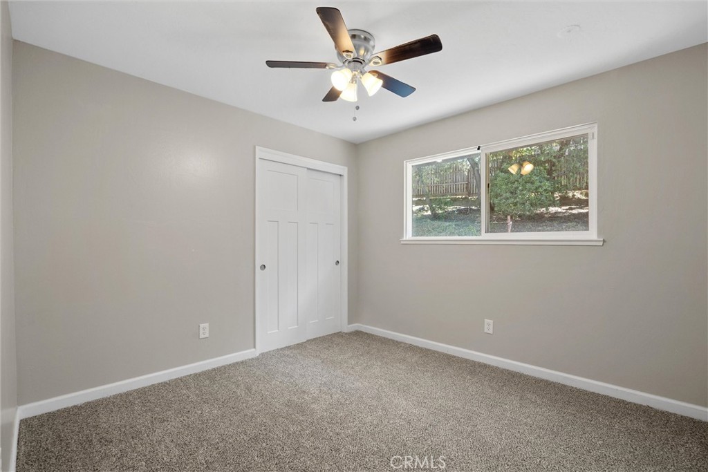 904 Long Bar Road Oroville, CA 95966 - Photo 37 of 50 an empty room with windows and ceiling fan