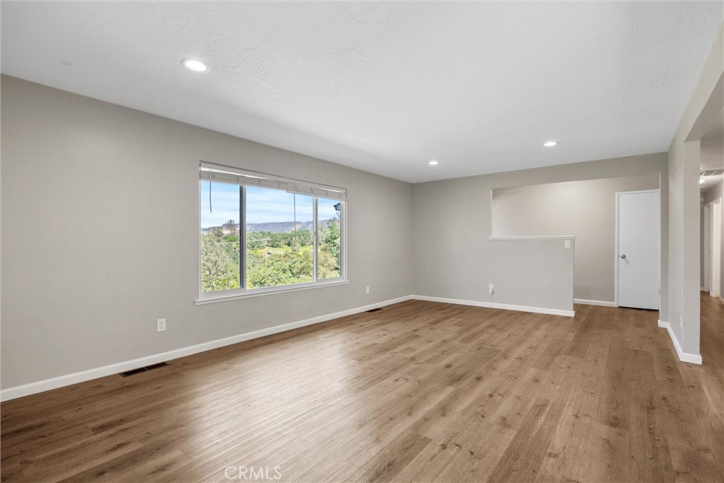 904 Long Bar Road Oroville, CA 95966 - Photo 10 of 50 an empty room with wooden floor and windows