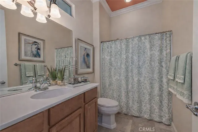 a bathroom with a sink vanity mirror and toilet