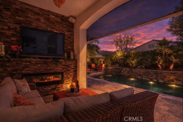 a living room with patio a fireplace and a flat screen tv