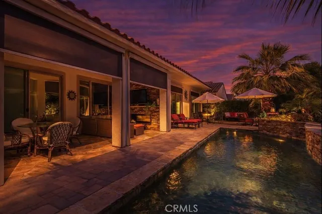 a swimming pool with outdoor seating and yard