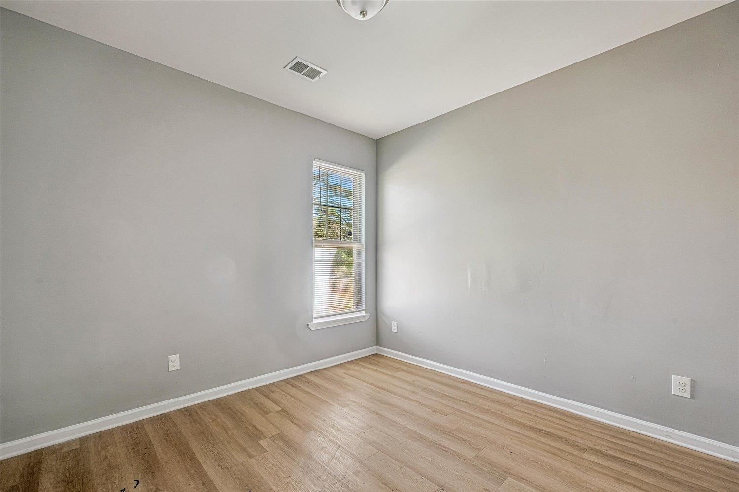 346 Delta Road Memphis, TN 38109 - Photo 13 of 23 an empty room with wooden floor and windows