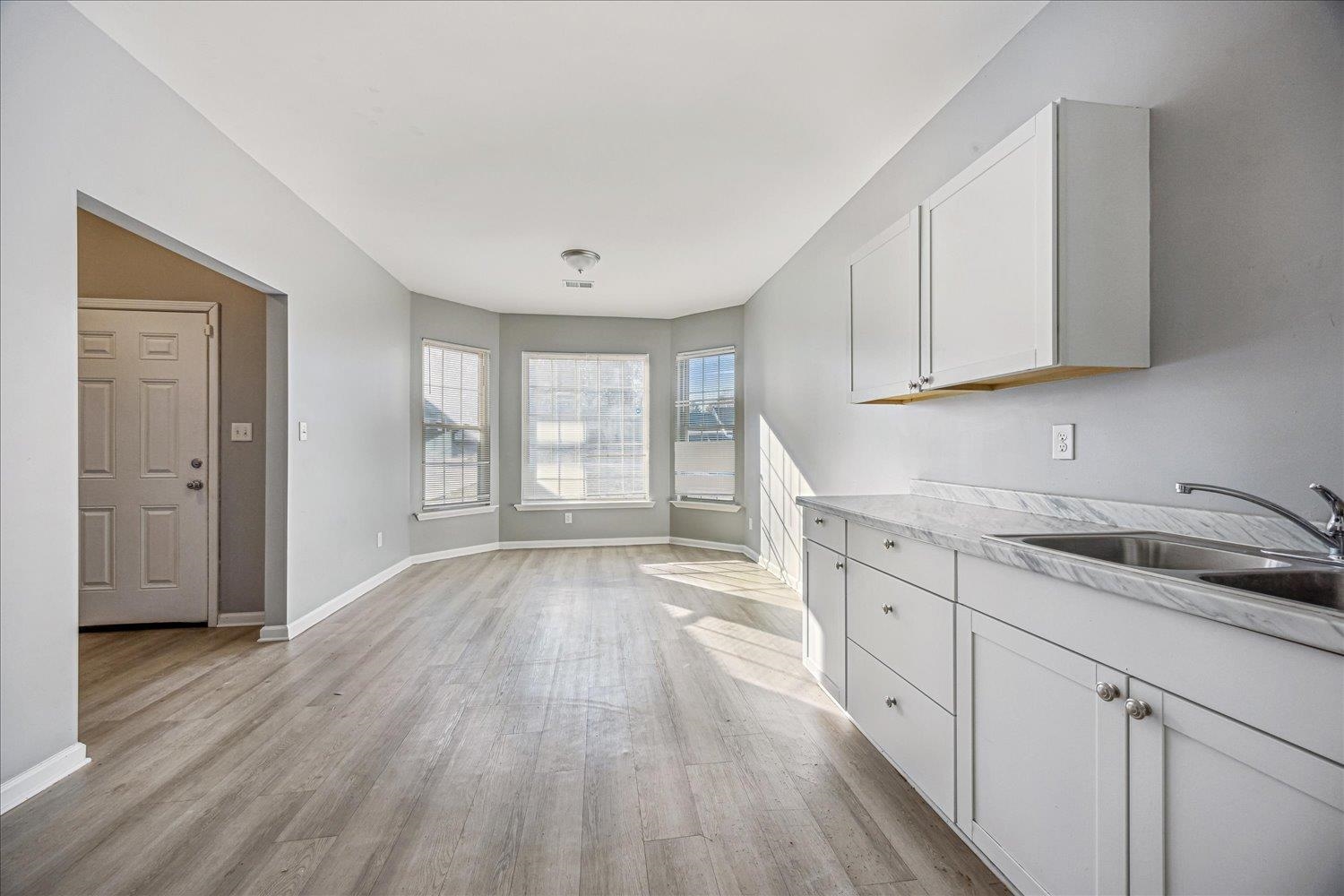 346 Delta Road Memphis, TN 38109 - Photo 5 of 23 a view of a kitchen with sink and dishwasher with wooden floor