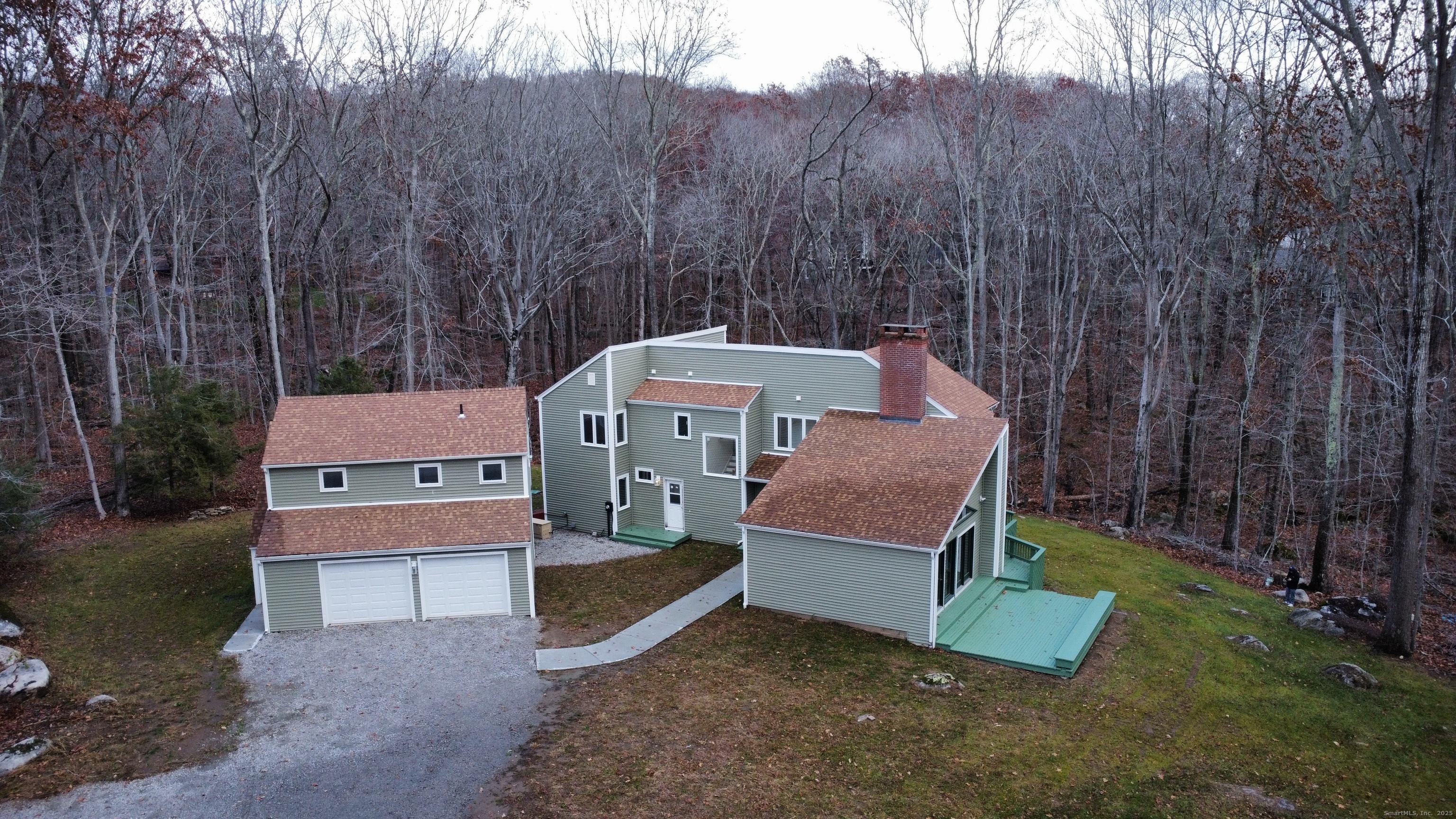 an aerial view of a house with a yard