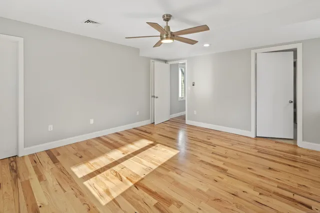 a view of a room with wooden floor and a window