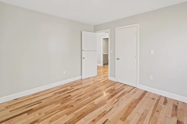 a kitchen with wooden floors and white cabinets