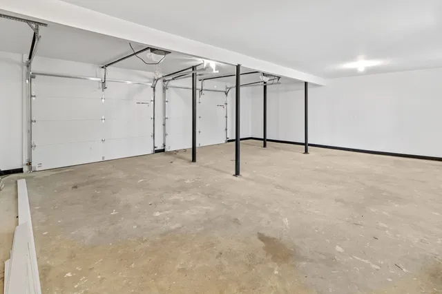 a kitchen with granite countertop a stove and white cabinets
