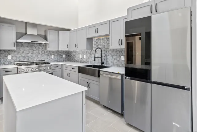 a kitchen with stainless steel appliances a sink and cabinets