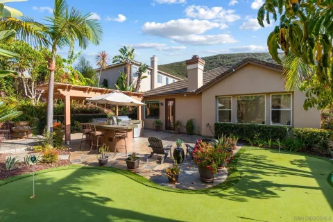 a front view of a house with swimming pool having outdoor seating