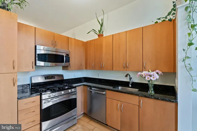 a kitchen with a sink cabinets and stainless steel appliances