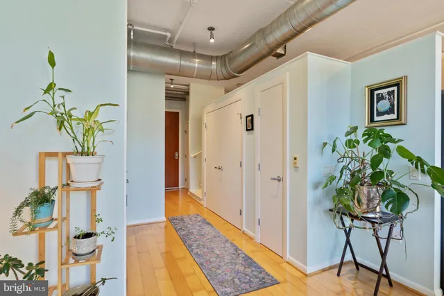 a hallway with painting and wooden floor