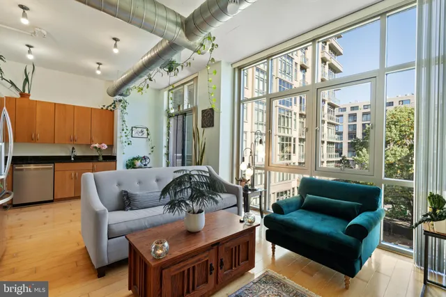 a living room with furniture and a large window
