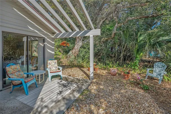 a view of a sitting area with chairs and wooden fence