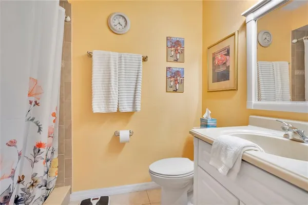 a bathroom with a sink a toilet and a window