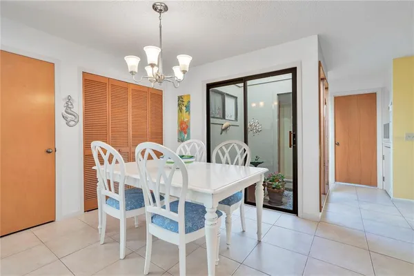 a view of a dining room with furniture and chandelier