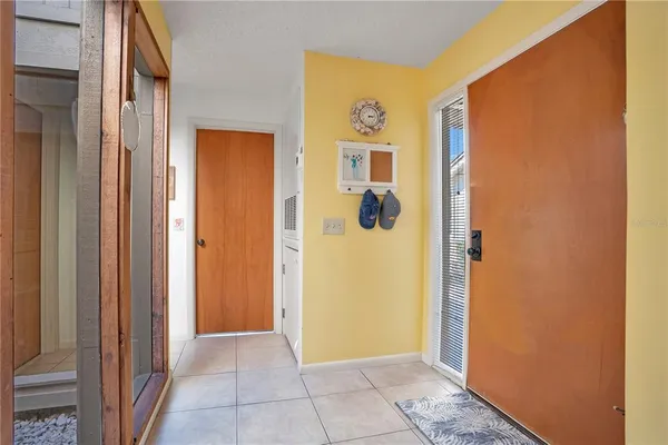 a bedroom with a bed couch and a large window