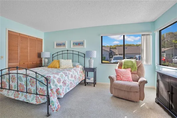 a bedroom with a bed a couch and dresser