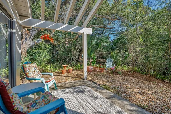 a backyard of a house with wooden floor and outdoor seating
