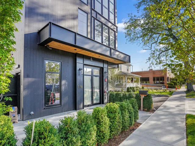 a view of a building with a lot of flower plants