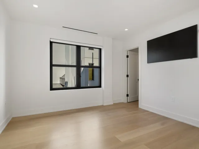 a view of an empty room with a flat screen tv