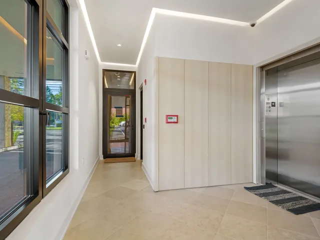 a view of a hallway with wooden shelves