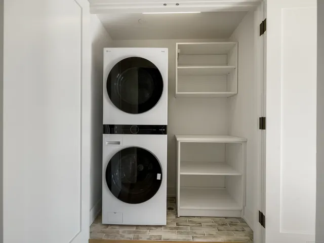 a view of a living room with washer and dryer