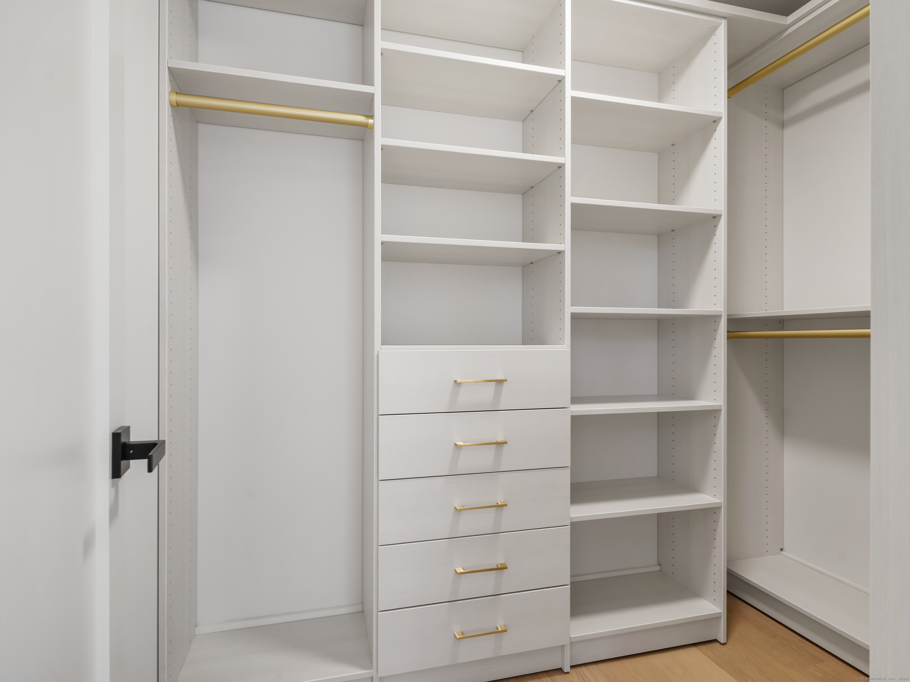 116 Sherman Street, Unit 1 Fairfield, CT 06824 - Photo 20 of 32 a view of walk in closet with empty racks