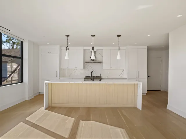 a spacious bathroom with a tub sink and mirror
