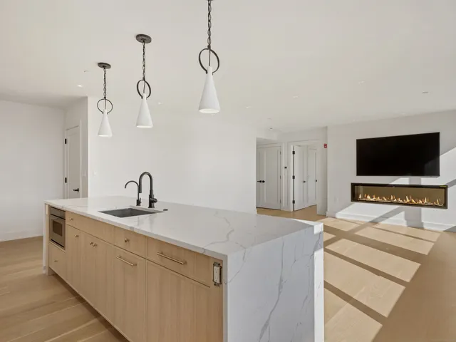 a kitchen with a sink and a stove top oven
