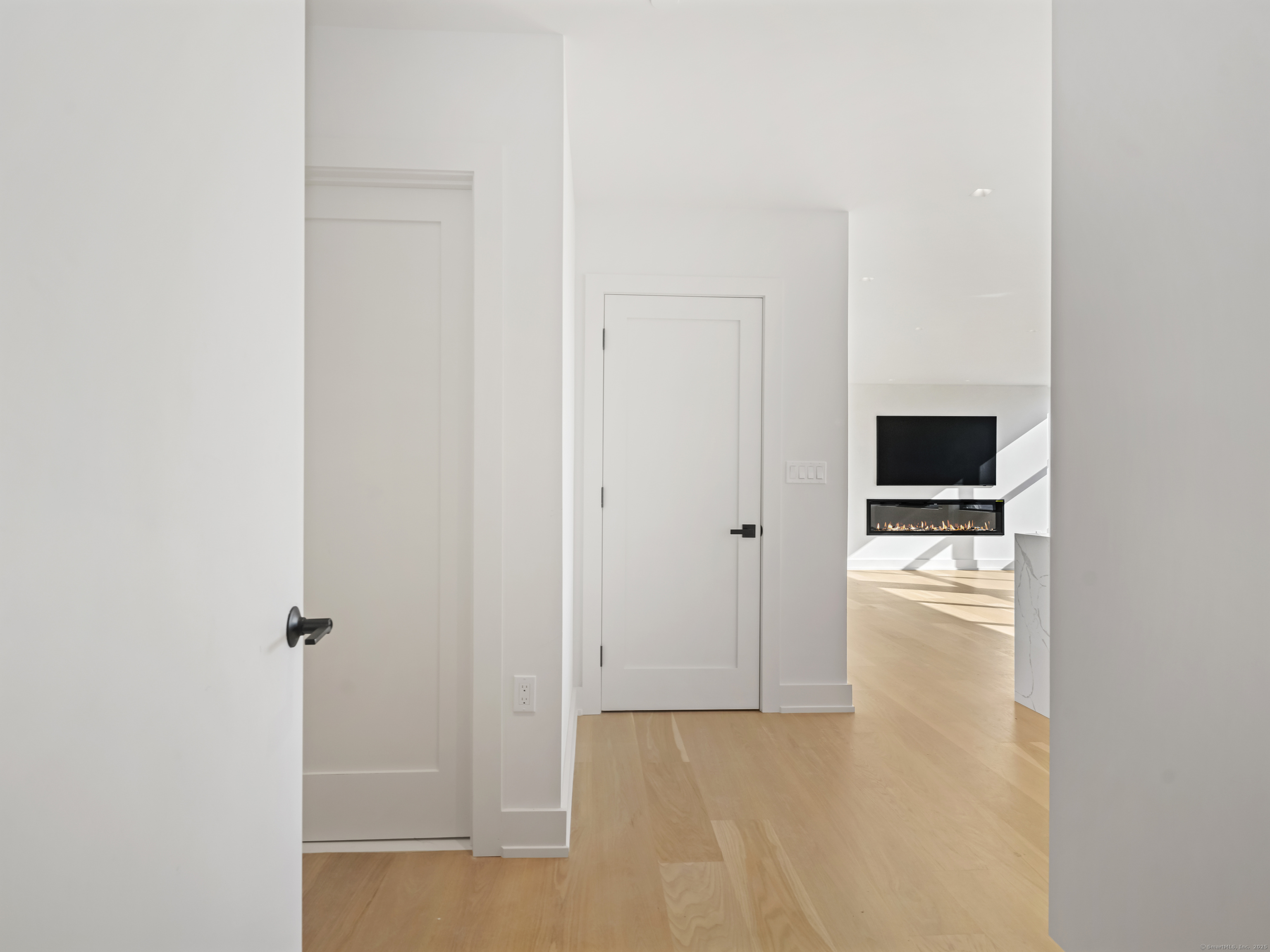 116 Sherman Street, Unit 1 Fairfield, CT 06824 - Photo 27 of 32 a view of a livingroom with an empty space and a refrigerator
