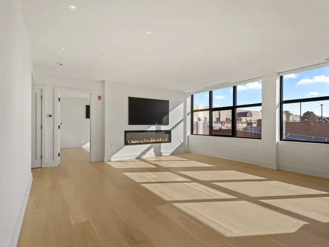 a room with a bed and a flat screen tv