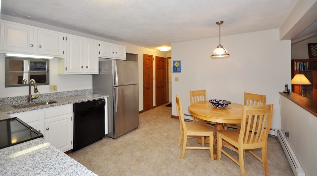 29 Blanchard Road Boxborough, MA 01719 - Photo 8 of 30 a kitchen with a table chairs refrigerator and microwave