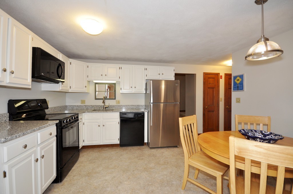 29 Blanchard Road Boxborough, MA 01719 - Photo 9 of 30 a kitchen with stainless steel appliances granite countertop a stove top oven a refrigerator a sink and dishwasher