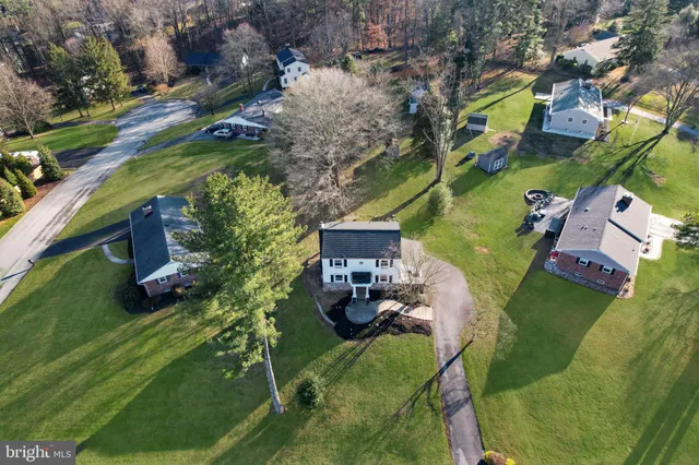 an aerial view of a house with a yard