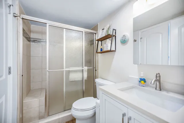 a view of a roof deck with table and chairs a barbeque with wooden floor and fence